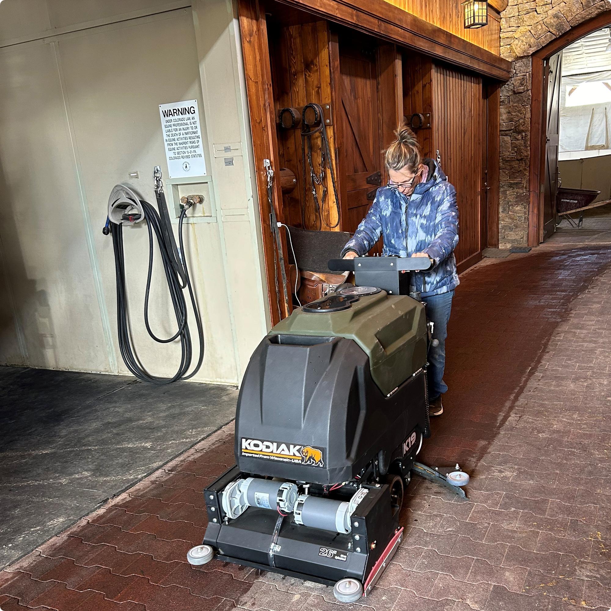 Kodiak - K19 – 26" Cylindrical Deck Floor Scrubber cleaning an interlocking paver floor in a horse barn IMG0014